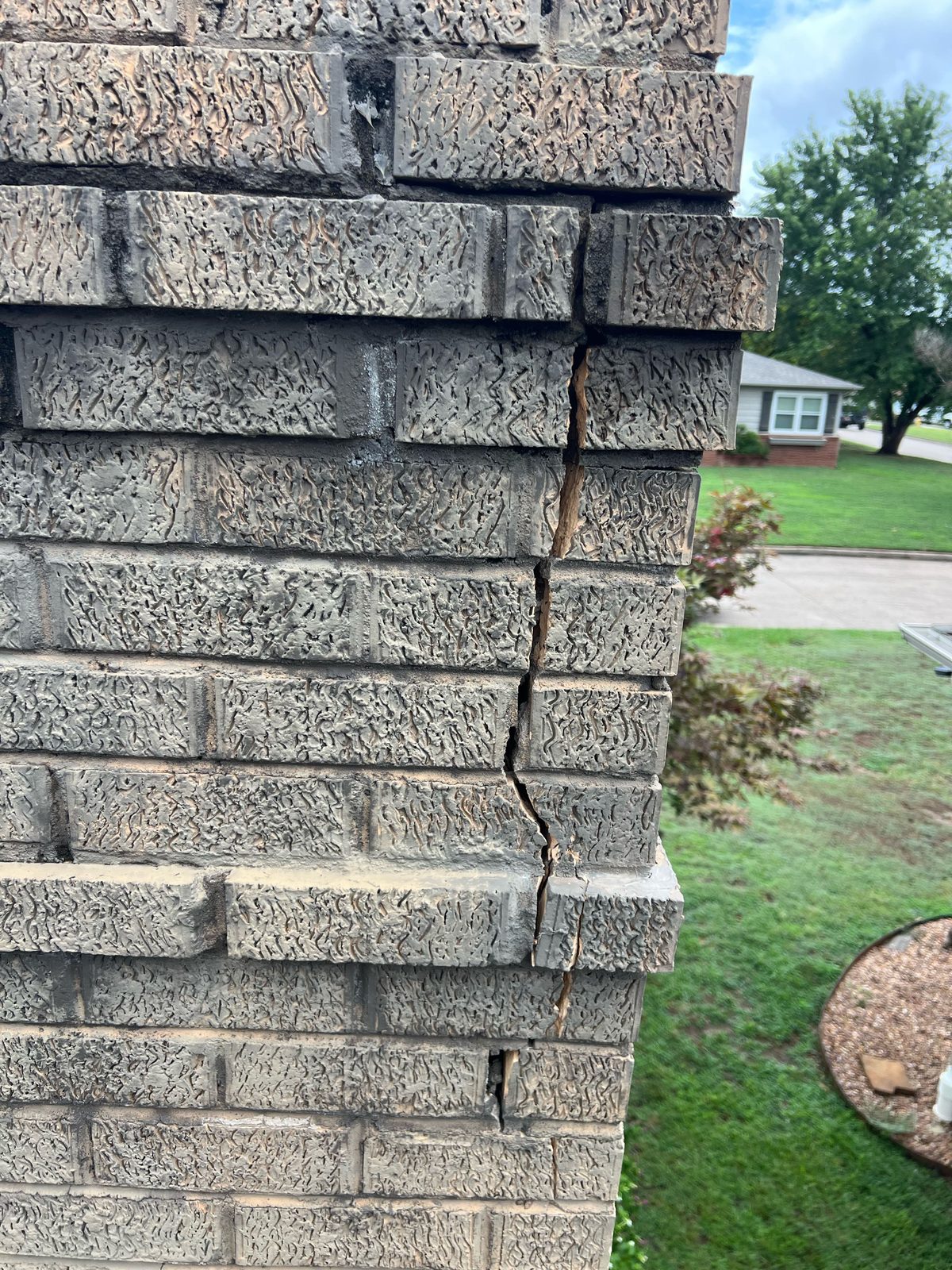 Lightning strike crack on brick chimney exterior