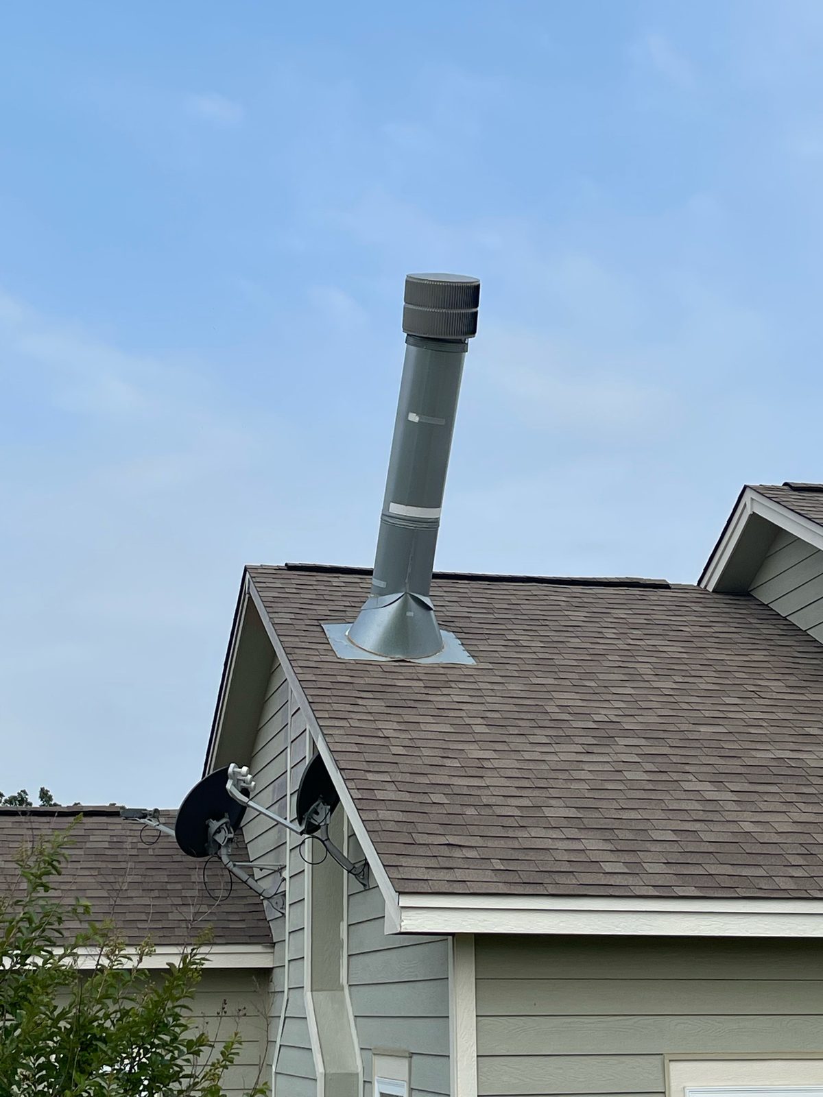 Bent chimney pipe on roof from storm damage