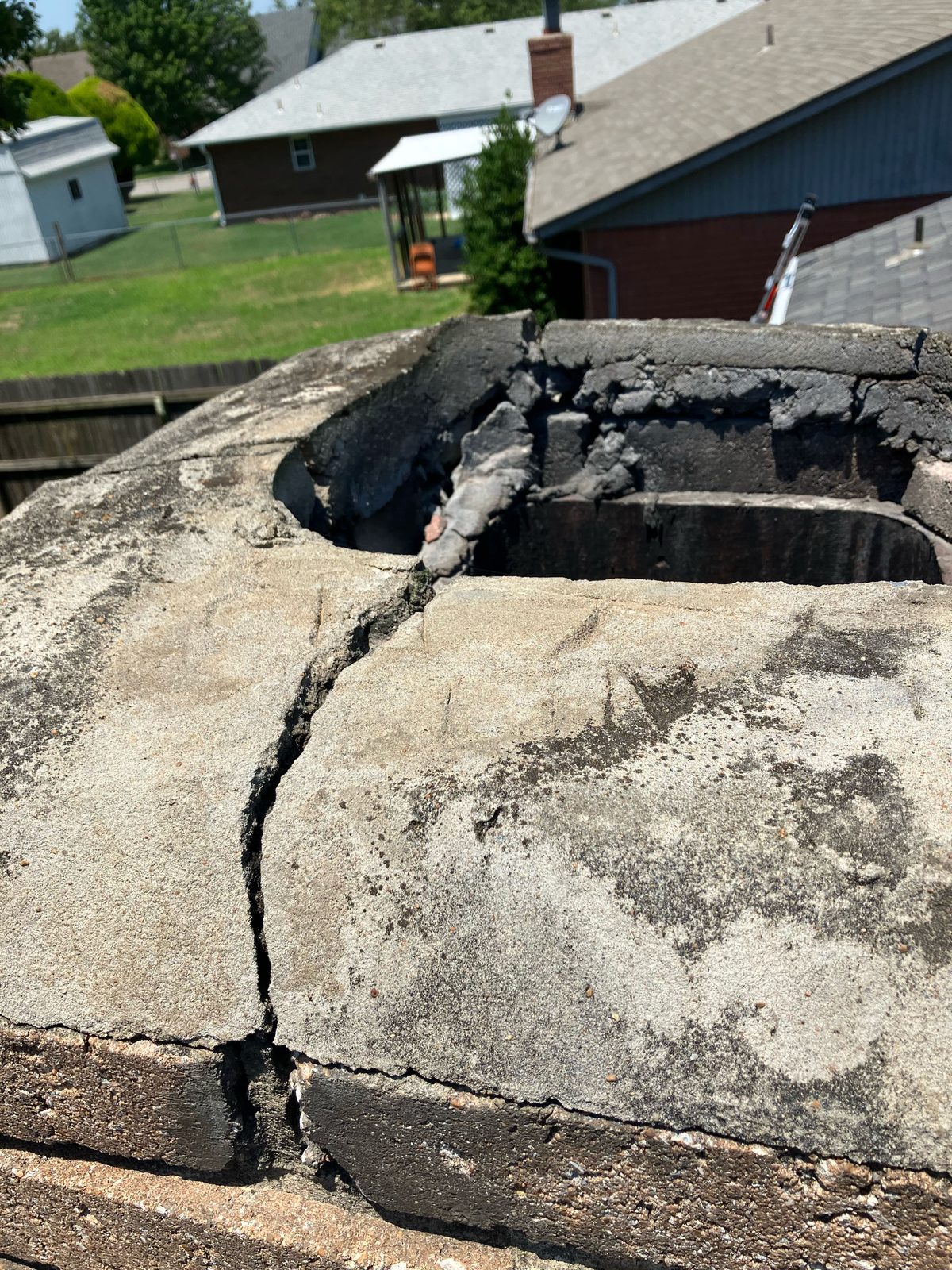 Cracked chimney crown from storm damage in Tulsa
