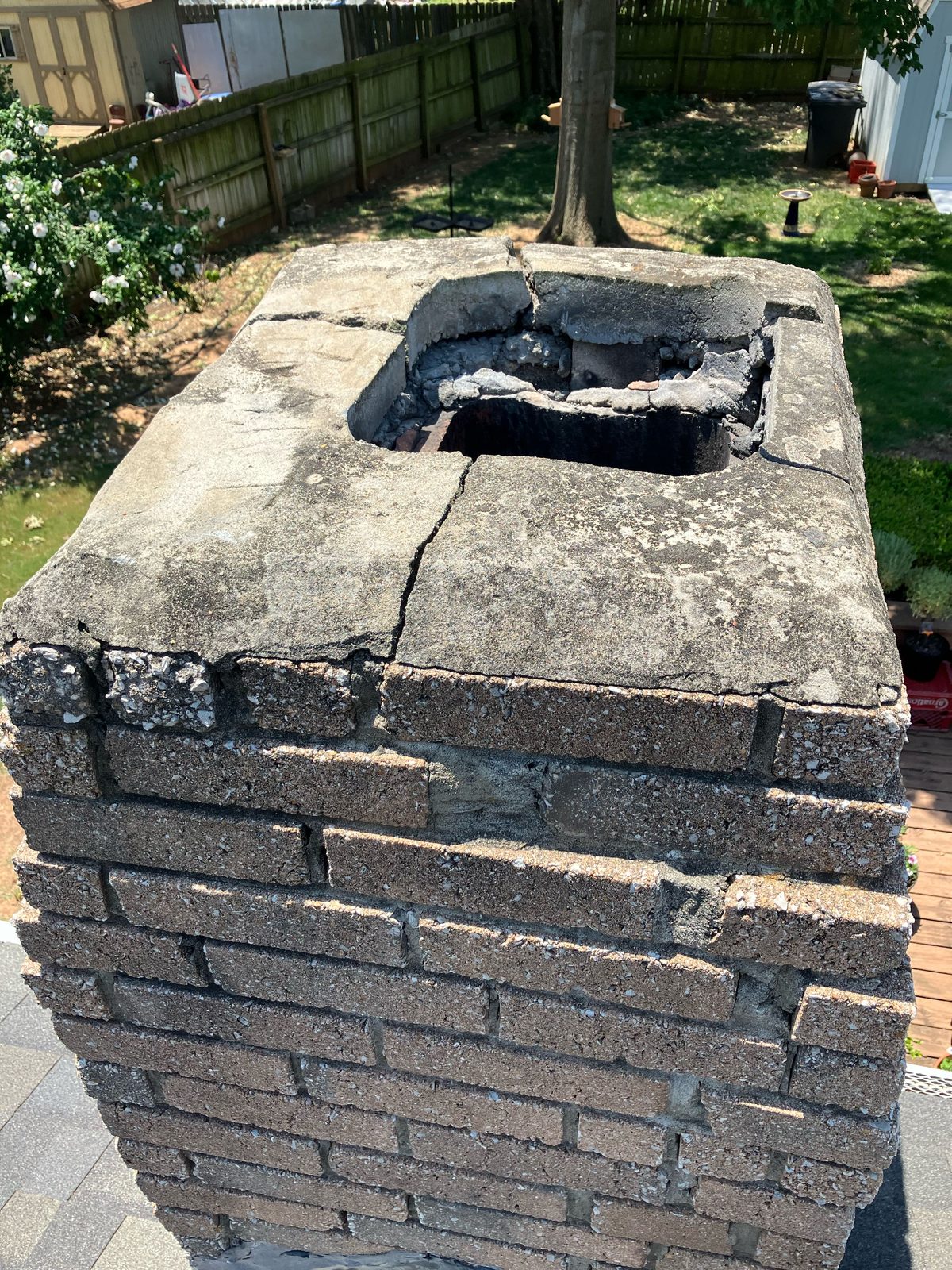 Severely damaged chimney crown with exposed flue opening