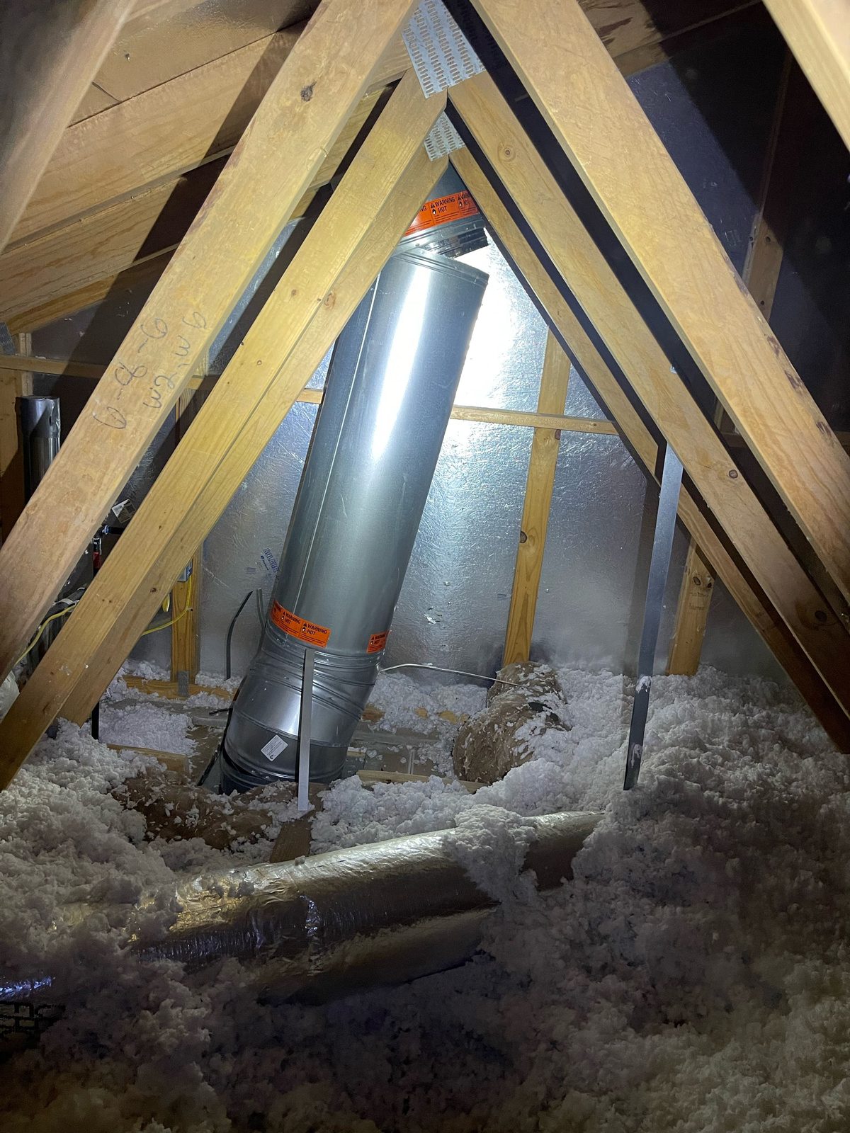 Disconnected chimney pipe inside attic from storm