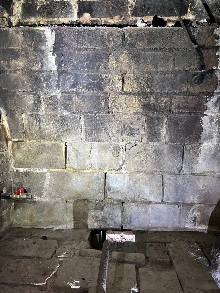 Worn, cracked firebrick in the back wall of an old Tulsa fireplace