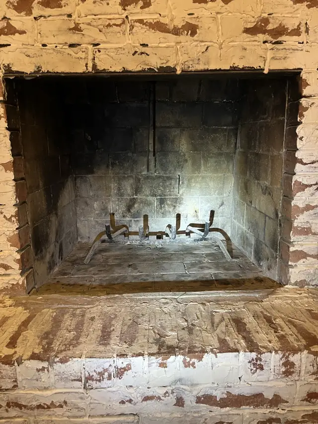 Worn brick fireplace opening and hearth